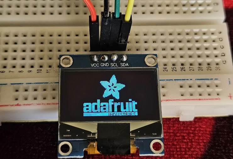 0.96" SSD1306 Oled display showing the Adafruit Logo